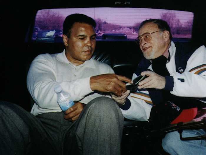 Muhammad Ali rides with Jerry Izenberg in the back of a car.